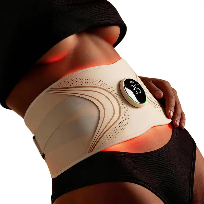 The Lumen belt worn over the lower belly with the warm red light glow visible across the band, photographed from the side in soft natural light